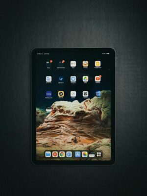 Top view of a tablet showing various digital applications on its touch screen, emphasizing technology.