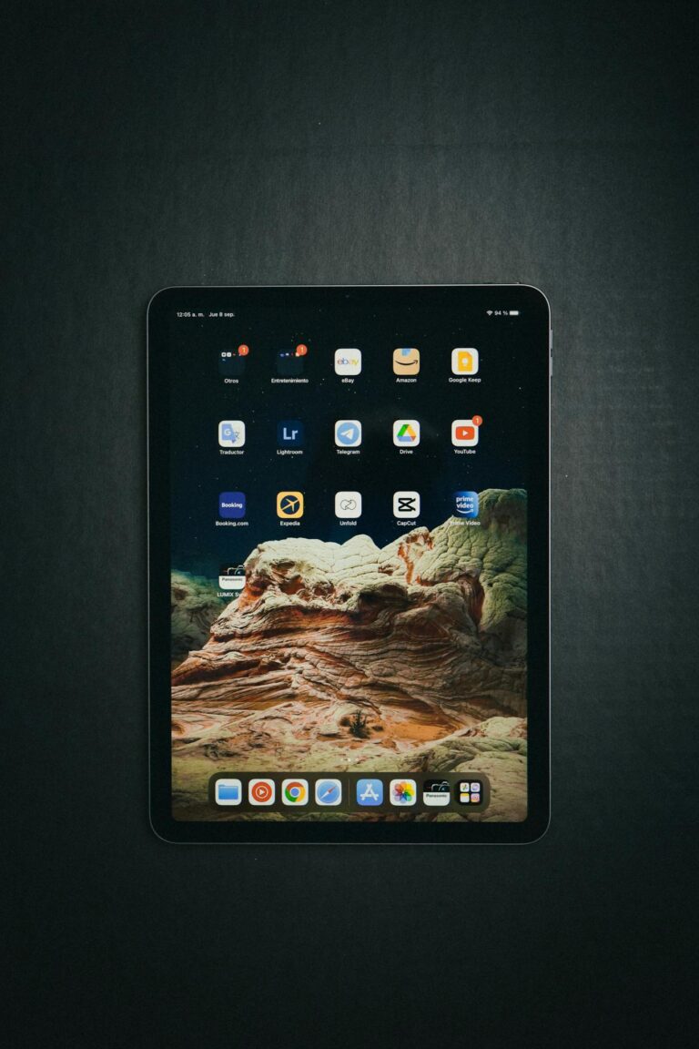 Top view of a tablet showing various digital applications on its touch screen, emphasizing technology.